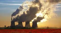 Cooling towers of a coal-fired power plant near a poppy field in Lincolnshire in the United Kingdom.