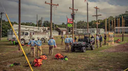 lineworkers standing by power poles