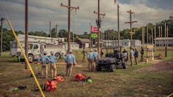 lineworkers standing by power poles lineworkers standing by power poles