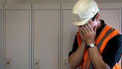 man in hard hat with face in hands man in hard hat with face in hands