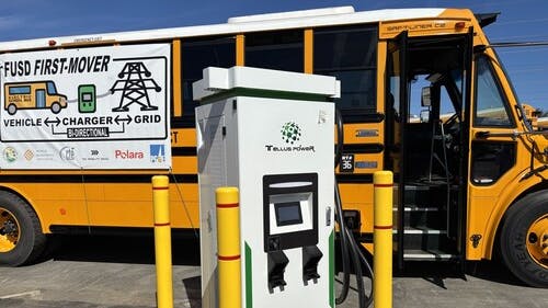 A Tellus Power bidirectional charger plugged into a Thomas Built electric school bus at the Fremont Unified School District bus depot.
