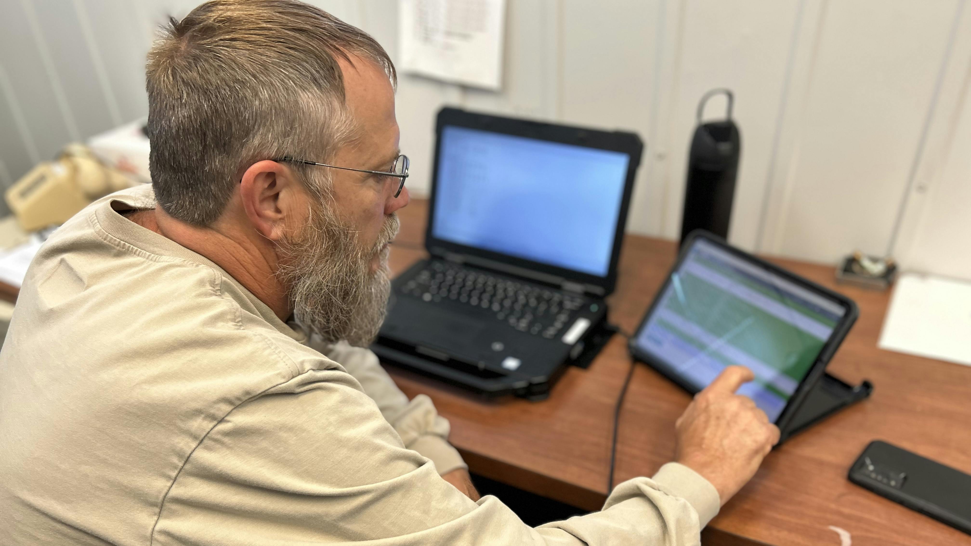Charles Tinch, a UCEMC substation technician, uses the eSMART platform on his iPad to conduct and log real-time inspection data, streamlining substation maintenance and reporting.