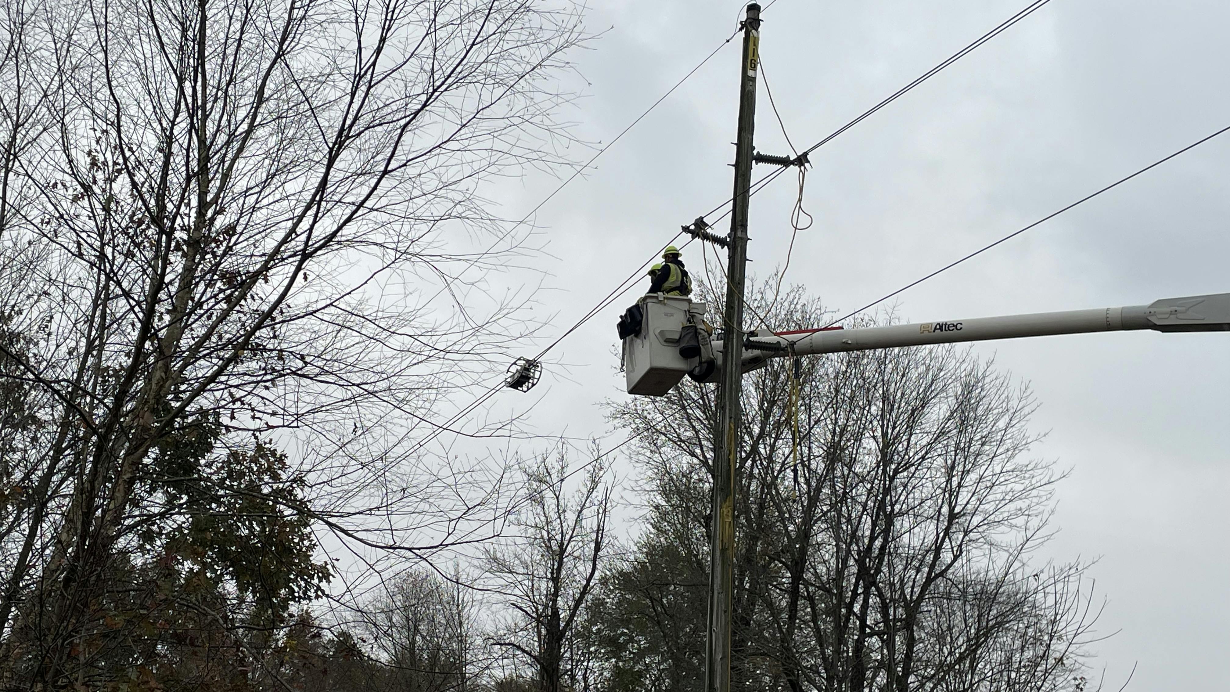 Ameren Illinois lineworkers place the LineVue robot onto sub-transmission power lines, while a lineworker or engineer on the ground operates the device to inspect sub-transmission power lines.