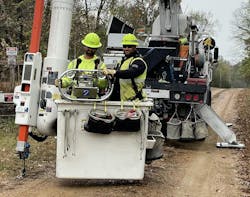 Alex Stout (left) and Kenton Parmley, Ameren lineworkers for the Anna, Illinois, operating center, place the LineVue robot on sub-transmission power lines in Joppa, Illinois. Alex Stout (left) and Kenton Parmley, Ameren lineworkers for the Anna, Illinois, operating center, place the LineVue robot on sub-transmission power lines in Joppa, Illinois.