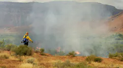 Firemen watch over a prescribed burn