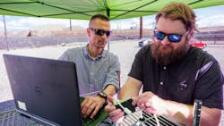 Sandia National Laboratories cybersecurity expert Adrian Chavez, left, and computer scientist Logan Blakely work to integrate a single-board computer with their neural-network AI into the Public Service Company of New Mexico’s test site. This code monitors the grid for cyberattacks and physical issues. Sandia National Laboratories cybersecurity expert Adrian Chavez, left, and computer scientist Logan Blakely work to integrate a single-board computer with their neural-network AI into the Public Service Company of New Mexico’s test site. This code monitors the grid for cyberattacks and physical issues.