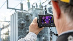 A worker uses an infrared camera to capture imagery of a transformer cooling fan bank. The photo is part of the eBook materials used to train workers on infrared inspection and leak detection. A worker uses an infrared camera to capture imagery of a transformer cooling fan bank. The photo is part of the eBook materials used to train workers on infrared inspection and leak detection.
