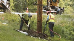 utility workers placing poles utility workers placing poles