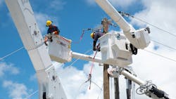 line workers in bucket trucks line workers in bucket trucks