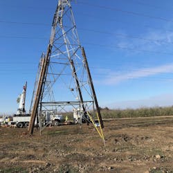 A tower with severe damage is stabilized with distribution poles and side guys before repair starts. A tower with severe damage is stabilized with distribution poles and side guys before repair starts.