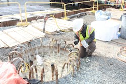 Congested cage being installed in an excavation. Congested cage being installed in an excavation.