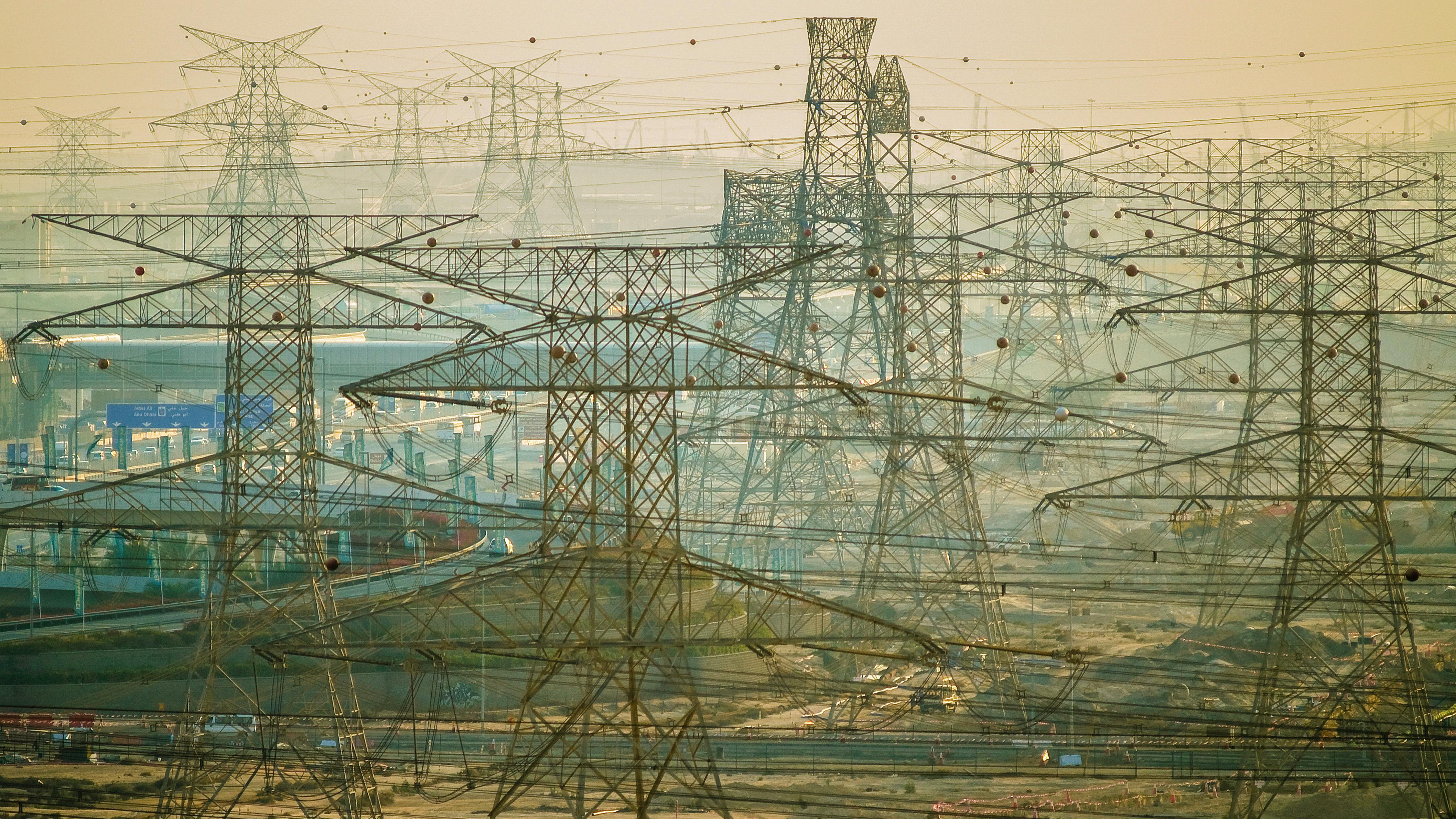 Power lines cross the landscape near Dubai, United Arab Emirates.