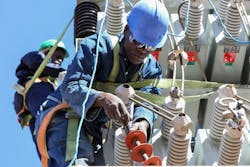 Workers servicing the power grid in Johannesburg, South Africa. Workers servicing the power grid in Johannesburg, South Africa.