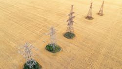 Aerial view over the agricultural fields. Yellow wheat and power lines Aerial view over the agricultural fields. Yellow wheat and power lines
