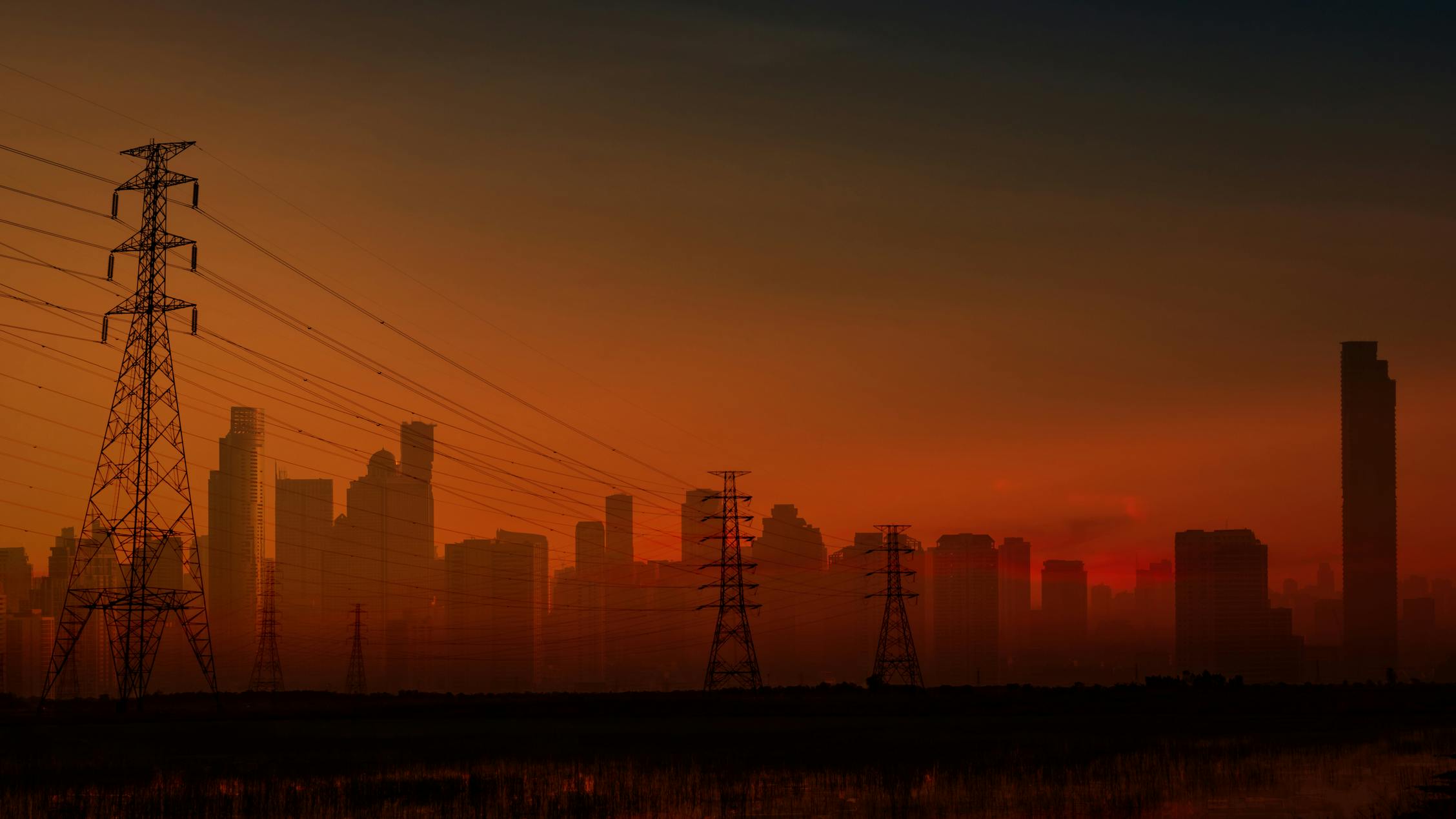 Blackout in Spain and Portugal shows dark cityscape with electricity pylon.