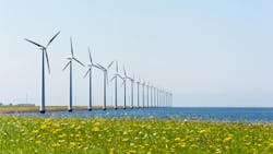 Dutch wind energy windmills near grassland and sea shore Dutch wind energy windmills near grassland and sea shore