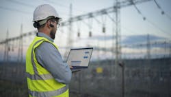 Successful engineer working on power plant with laptop Successful engineer working on power plant with laptop