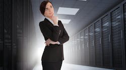 Businesswoman looking thoughtful in data center with light shining in the darkness Businesswoman looking thoughtful in data center with light shining in the darkness