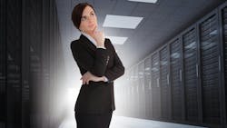 Businesswoman looking thoughtful in data center with light shining in the darkness Businesswoman looking thoughtful in data center with light shining in the darkness