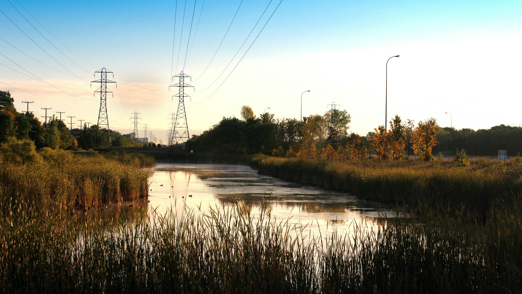 A pond by Bishop Grandin greenway photographed at sunrise