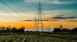 High voltage AC transmission towers during sunset time on Prairie High voltage AC transmission towers during sunset time on Prairie