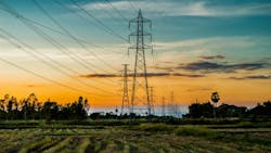 High voltage AC transmission towers during sunset time on Prairie High voltage AC transmission towers during sunset time on Prairie