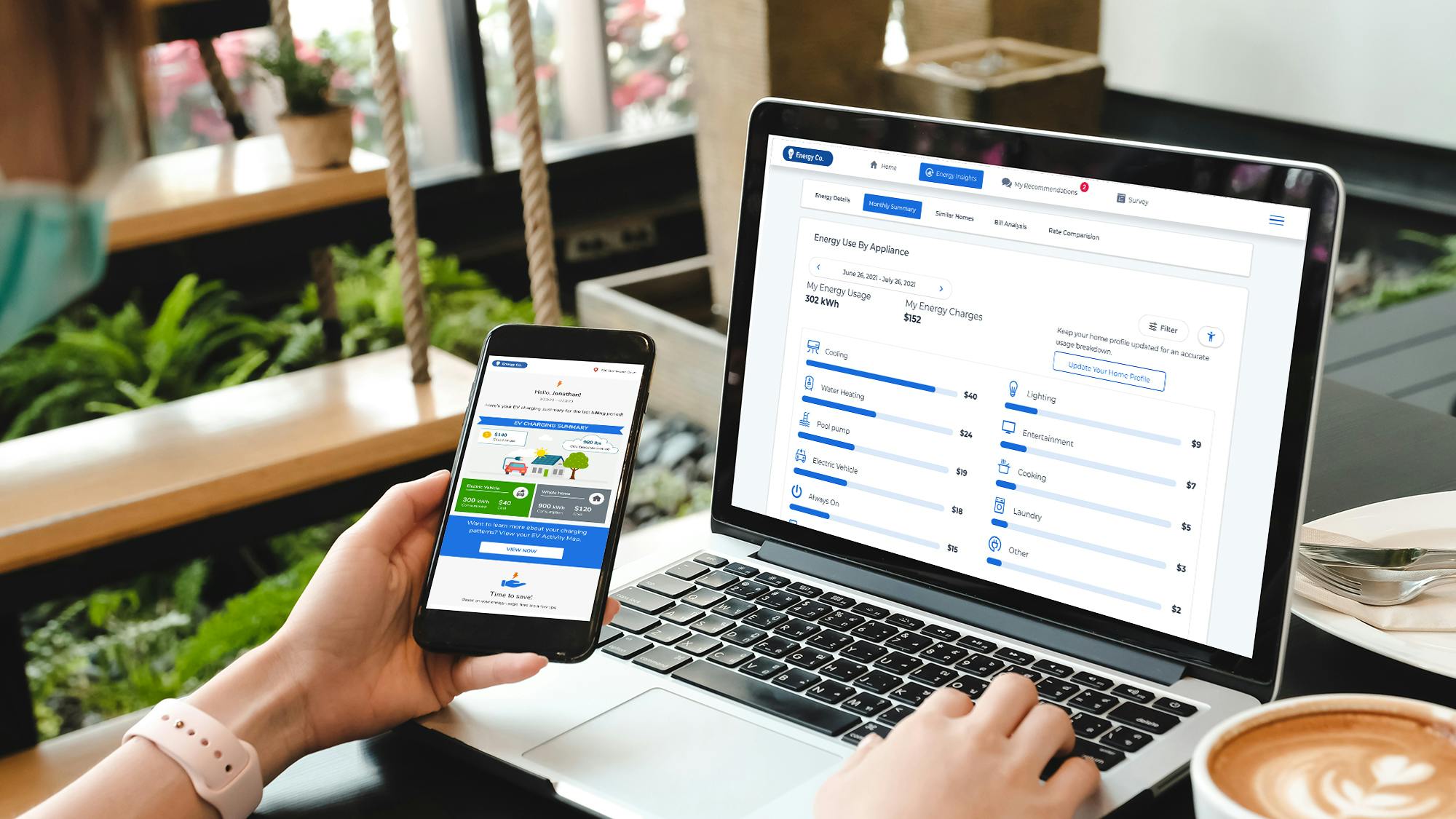 hand holding phone with app in front of computer