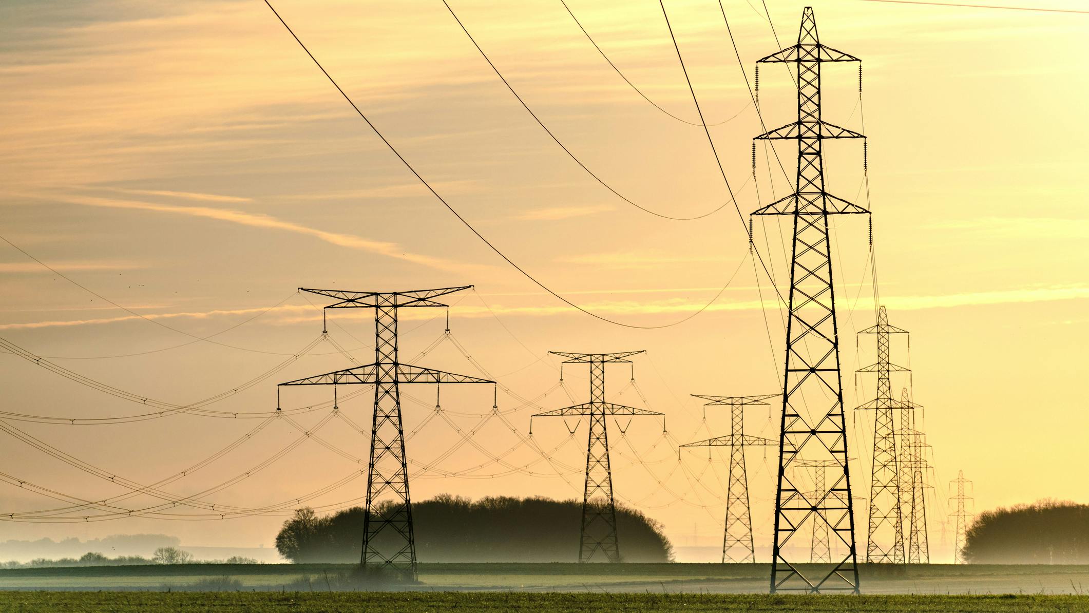 Sunrise with an electricity pylon and nature