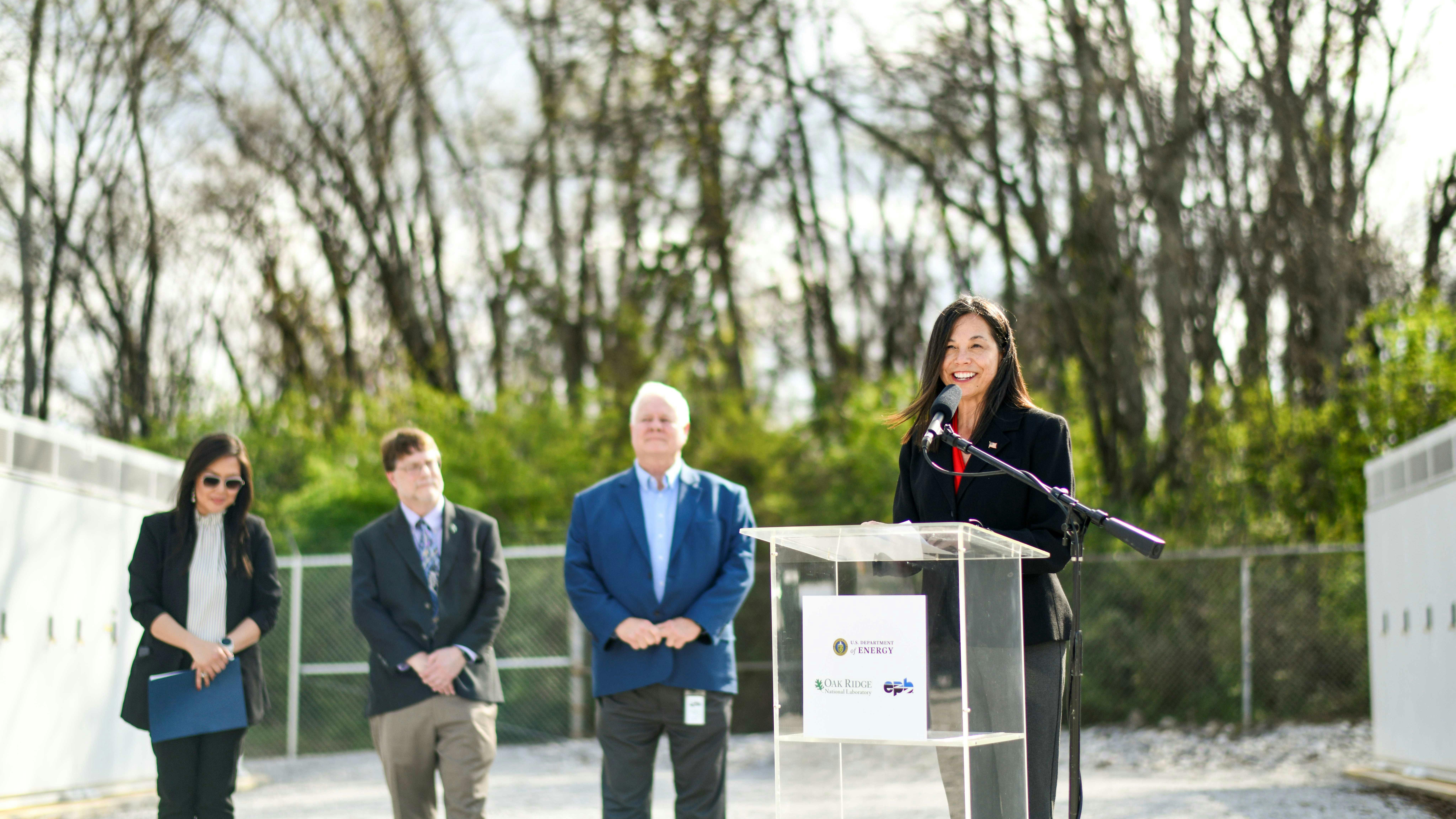 woman at microphone by microgrid