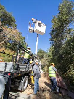 Workers in a bucket lift Workers in a bucket lift