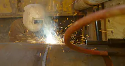 A CenterPoint lineworker welds together underground electric infrastructure. A CenterPoint lineworker welds together underground electric infrastructure.