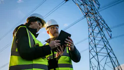 engineers in front of power lines with ipad engineers in front of power lines with ipad