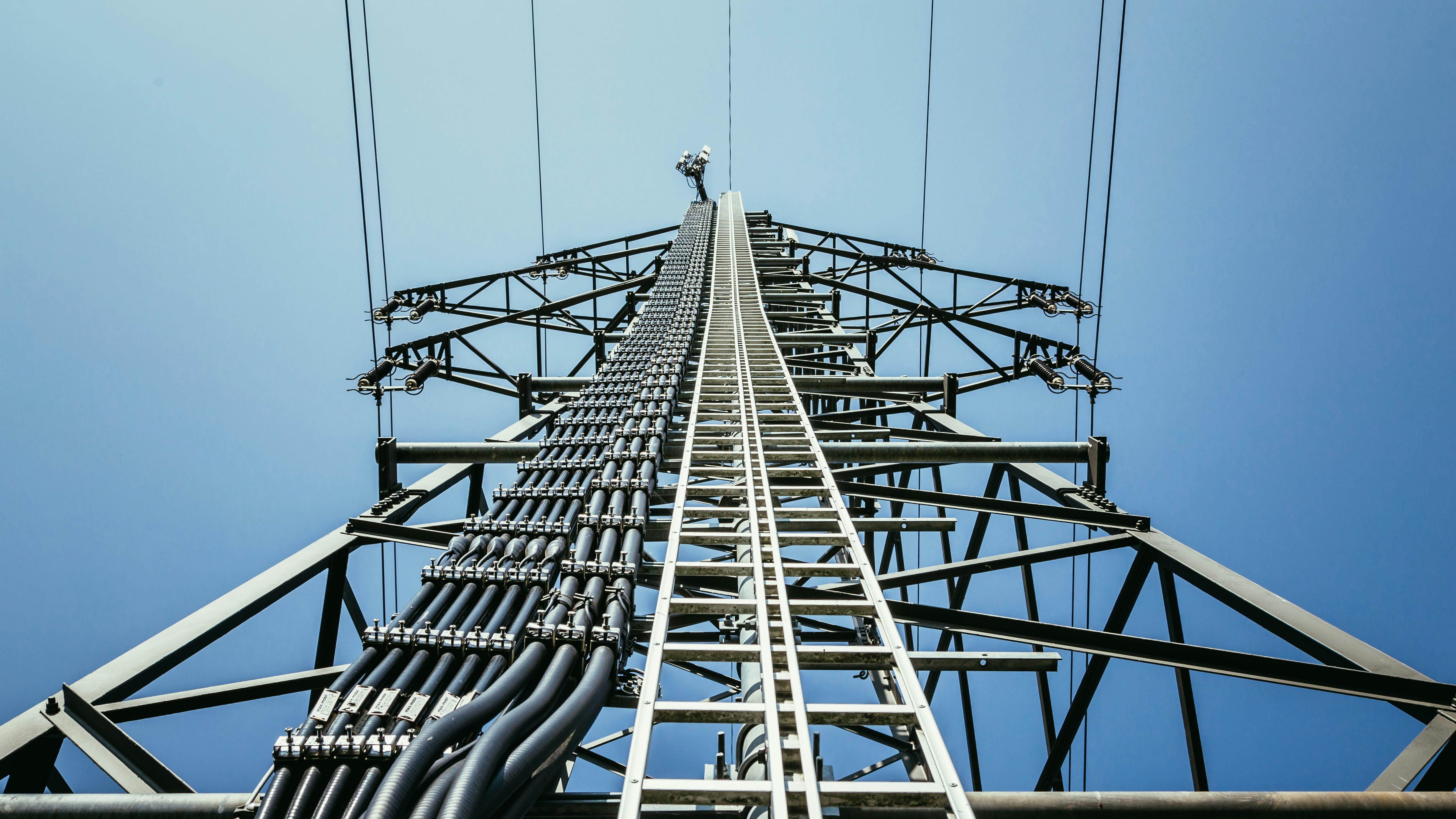 Close up of electrical tower and blue sky. Renewable energy and smart grid.