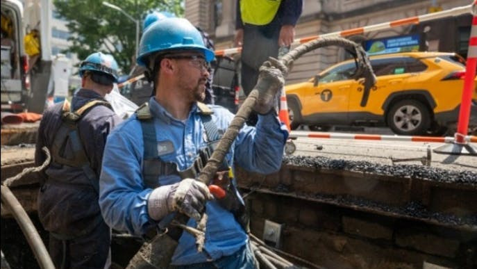 utility worker in manhole