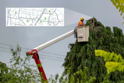 A bucket truck crew manages vegetation along the utility right-of-way.