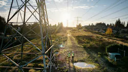 power lines by puddle with workers