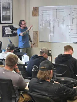 In the classroom, Bill White explains transformer bank wiring to his students.