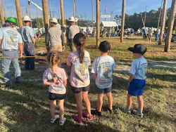 Brittany Burrell's daughter watches her dad compete at the Lineman's Rodeo along with the children of the other teammates.