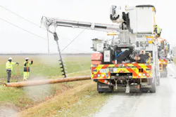 ComEd crews replace a utility pole in the aftermath of a tornado.