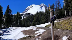 A contractor installs new lights at Mount Hood Meadows ski resort near Government Camp, Ore. Portland General Electric is undergrounding approximately seven miles of powerlines near Government Camp to protect Timberline, Mount Hood Meadows, Skibowl and the surrounding communities from the increasing threat of wildfire.