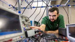 A student testing equipment inside an engineering lab in the EPIC building at UNC Charlotte.