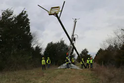 Ameren crews install a pole with a built-in nest box frame for ospreys.