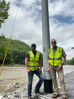 Josh Baker, McWane Poles Southeast Regional Sales Manager, and Rick Simpson, ELUS Company Sales Associate, stand alongside a newly installed McWane Pole for Erwin Utilities.