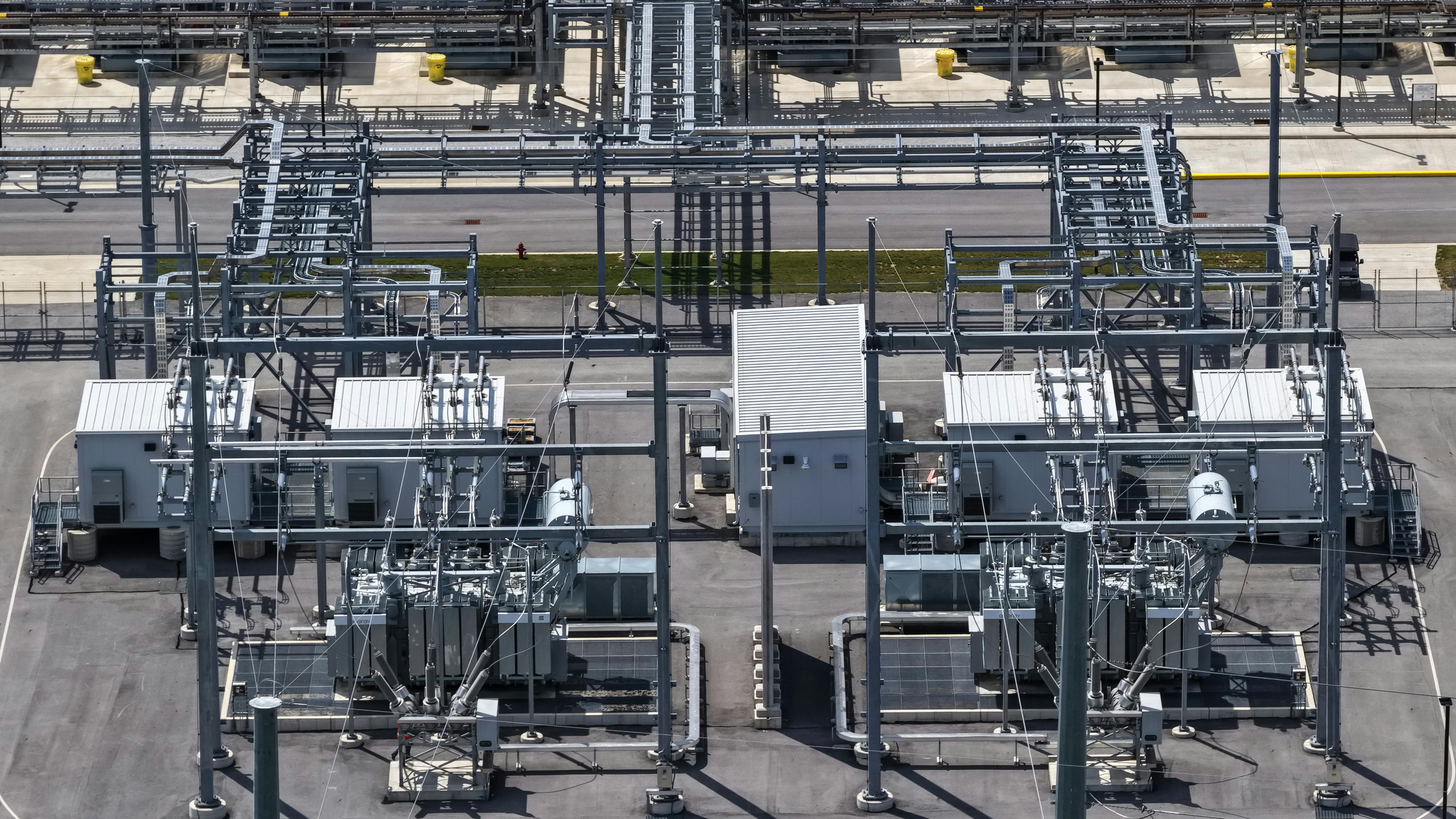 Existing power utility substation with transformers and high-voltage power lines. The type of infrastructure GridCARE aims to optimize and unlock capacity.