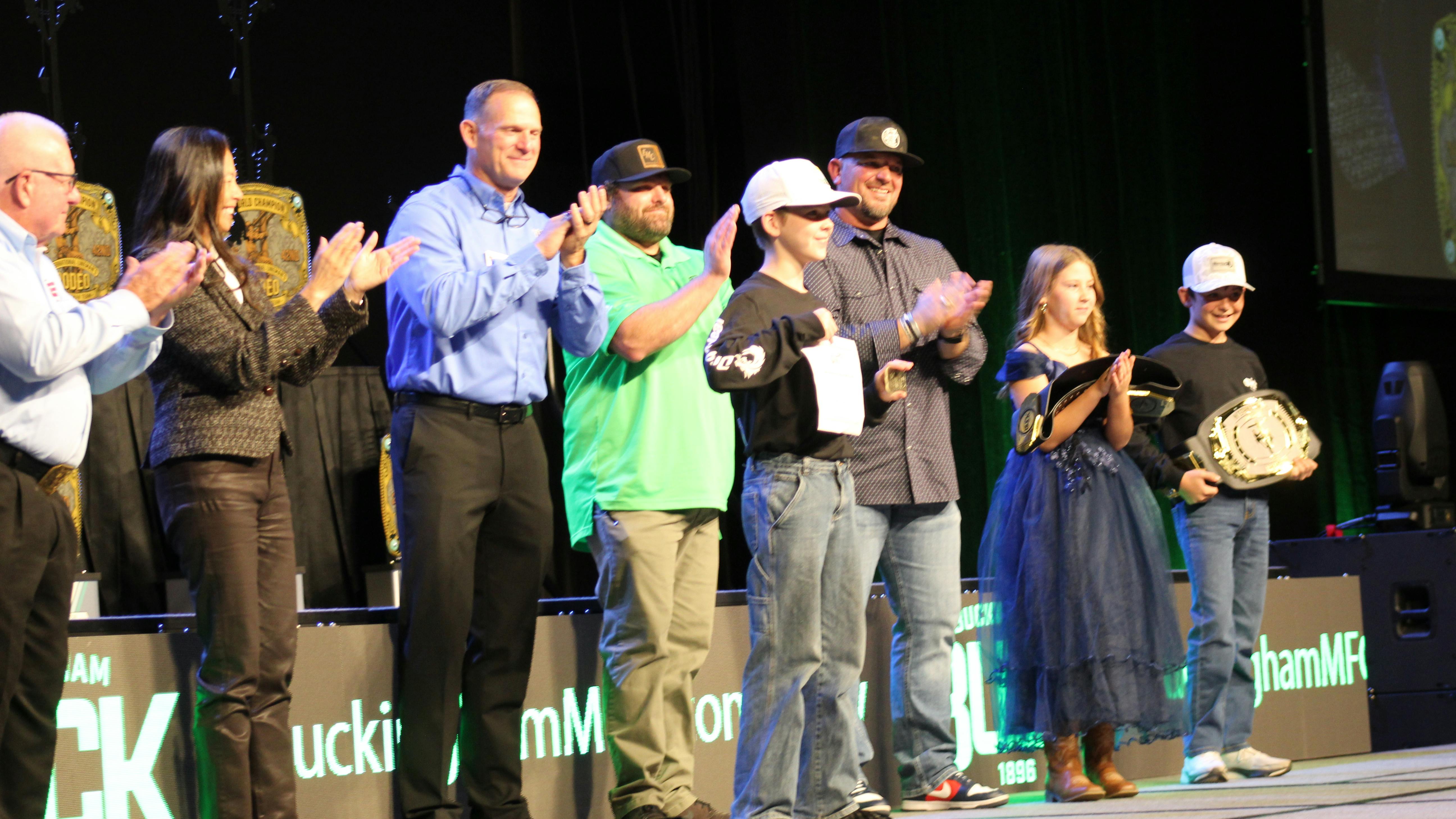 The award presenters and audience celebrated the three winners of the International Lineman's Kid's Rodeo.