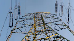 Energy grid infrastructure with high voltage pylons.